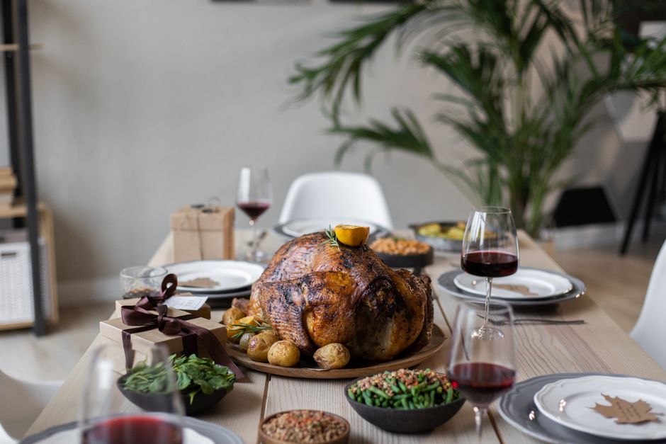 Thanksgiving tafeldecoratie met herfstbladeren en kaarsen.